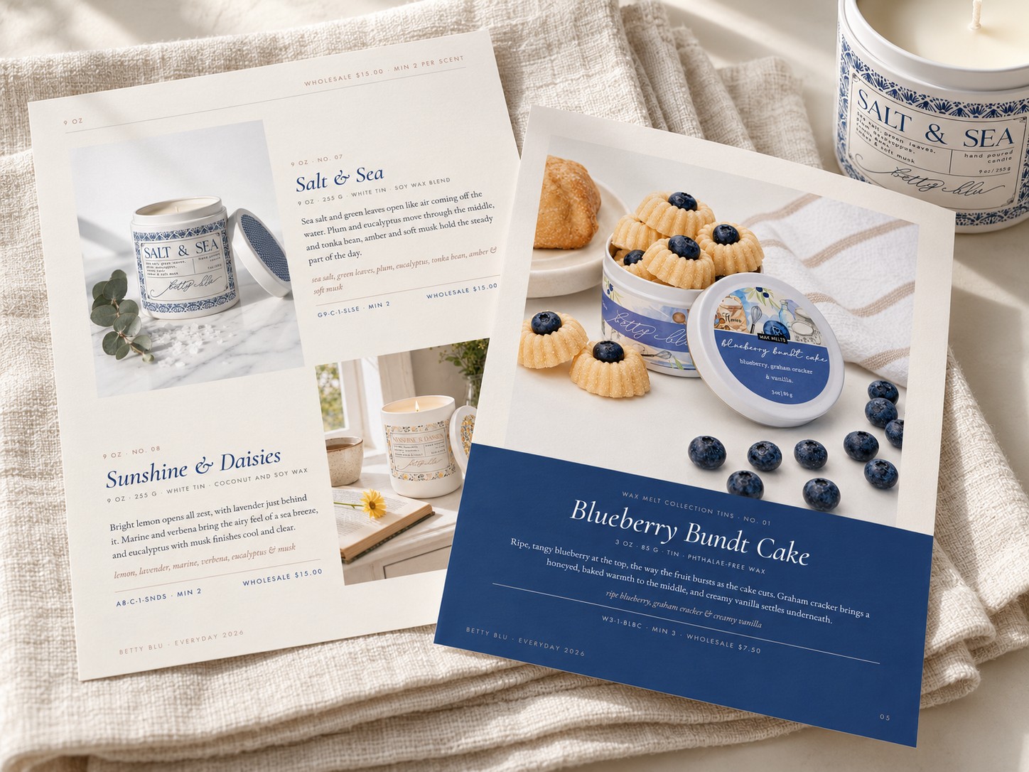Two printed lookbook pages for a candle and wax melt brand, laid on linen